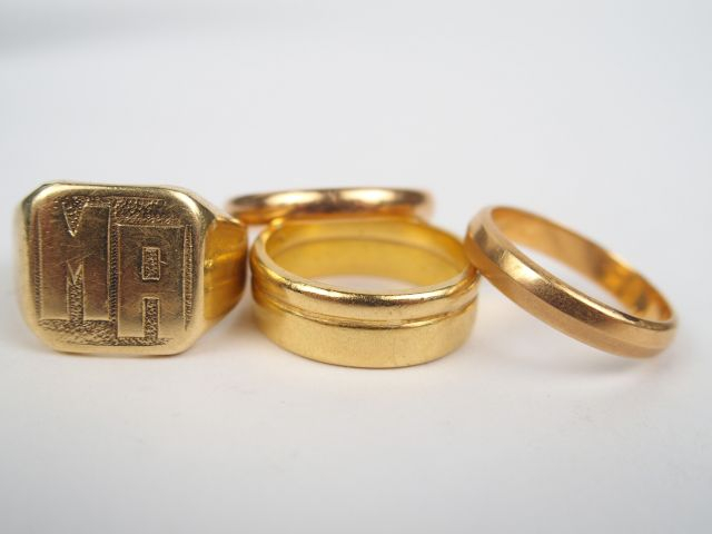 3 alliances et une chevalière monogramée MA en or jaune. Poids: 22gr