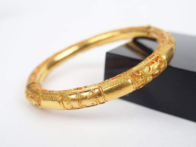 Bracelet jonc en or jaune 14K, gravures à décor de feuillages. Poids: 