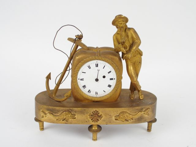 Pendulette XIX ème en bronze à décor d'un marin accoudé à une balle de