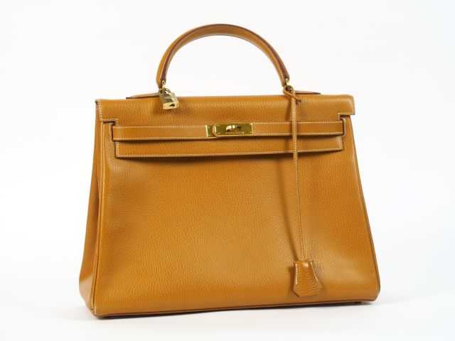 HERMES. Sac Kelly en cuir gold avec sa boite et son étui. L. 35 cm