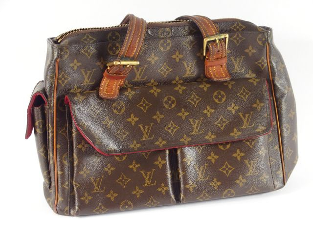 Louis VUITTON. Sac en cuir monogrammé (usé).