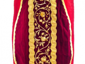 Vente aux enchères Chasuble en velours rouge. Au dos, croix de galon or décorée d'entrela