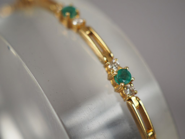 Bracelet articulé en or jaune, orné de onze émeraudes et de vingt-deux