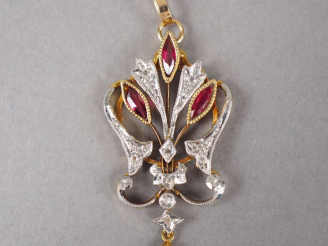 Vente aux enchères Pendentif en or jaune, orné de trois rubis, d'éclats de diamant et d'u