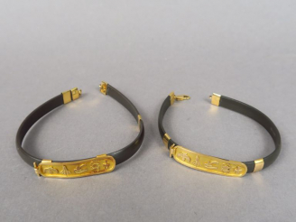 Vente aux enchères Deux bracelets de style égyptien en caoutchouc et or.  Poids tel. 15,7