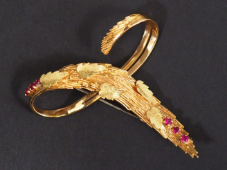 Vente aux enchères Broche en or jaune en forme de motif stylisé, à décor de feuilles et d