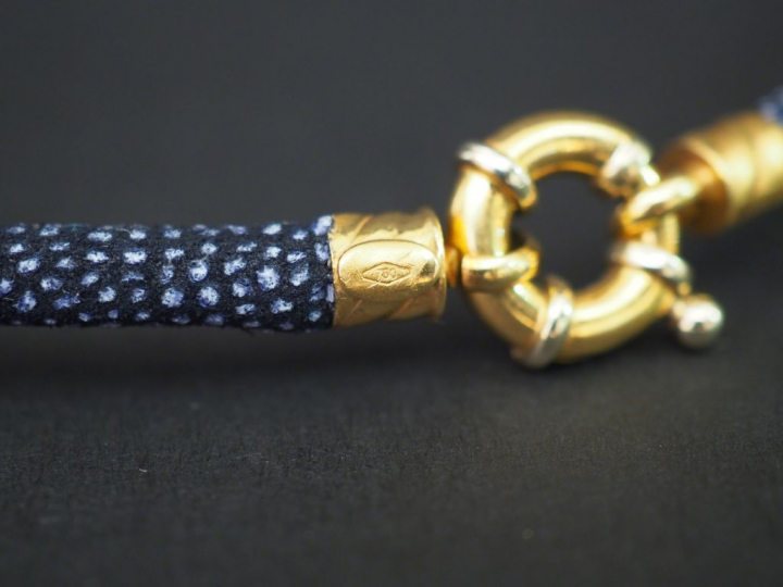 Collier ras de cou composé d'un cordon bleu marine et gris.  Fermoir e