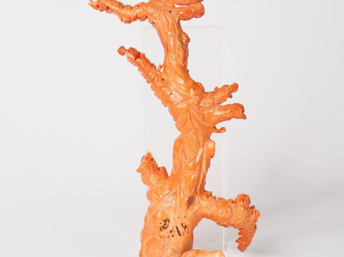 Statuette en corail couleur peau d'ange décor d'une divinité accompaag