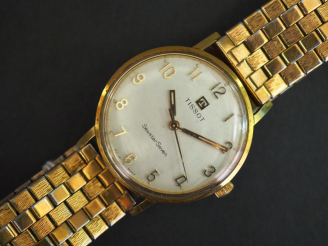 Vente aux enchères TISSOT, Seastar Seven Montre bracelet d’homme en plaqué or.  Cadran ro