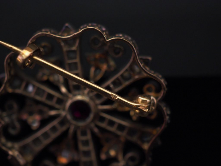 Broche ronde en or jaune et argent, en forme de rosace ajourée, sertie