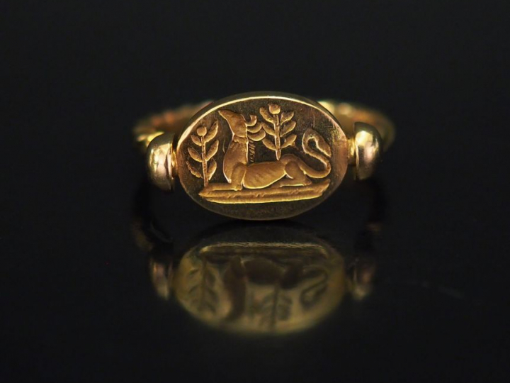 	Bague en or jaune, ornée en son centre d’un médaillon ovale imitant u