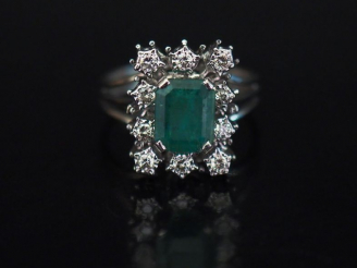 Vente aux enchères Bague en or blanc, sertie en son centre d'une émeraude entourée de dix