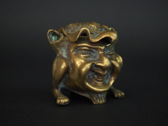 Vente aux enchères Encrier en bronze représentant une figure de grotesque. H.8 cm.