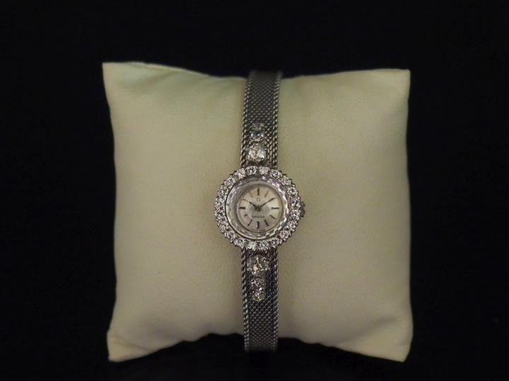 OMEGA.  Montre de dame en platine, cadran orné de diamants et bracelet