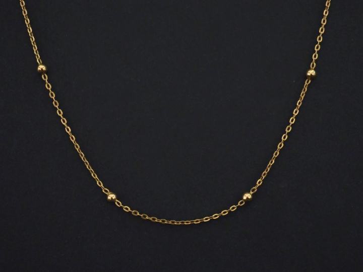 Chaine en or jaune 750, maille forçat, agrémentée de petites boules.  