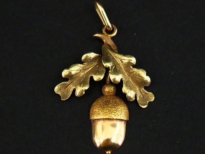 Pendentif en or 750, à décor de gland et feuilles de chêne.  3 x 2,2 c