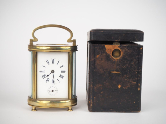 Vente aux enchères Pendulette de voyage dite d'officier en laiton et cristal, avec sa clé