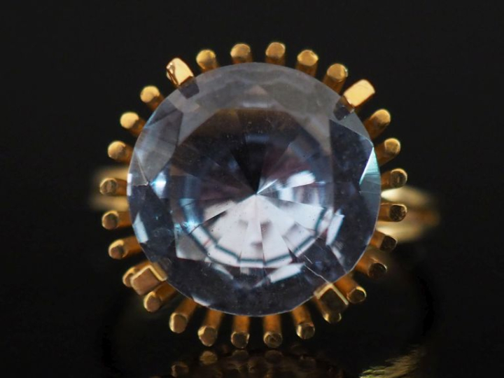 Bague en or jaune 750, sertie en son centre d'une pierre bleu ciel. Jo