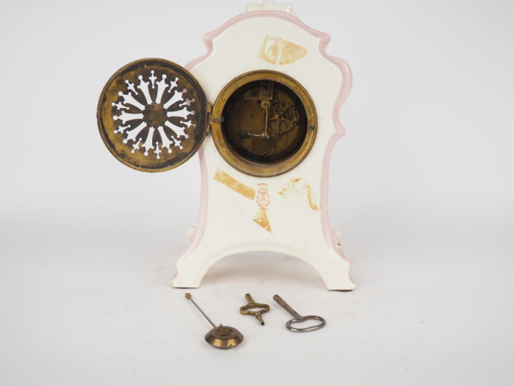 ROYAL BONN. Pendule 1900 en céramique à décor de fleurs sur fond rose.