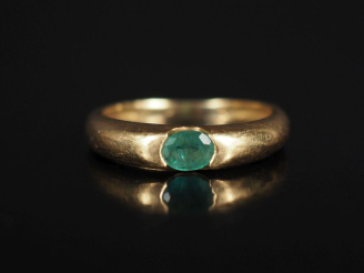 Vente aux enchères Bague jonc en or jaune 750, sertie en son centre d'une émeraude.  TDD.