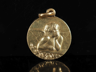 Vente aux enchères Médaille en or jaune 750, figurant un angelot.  Diam. 1,8 cm Poids. 3,