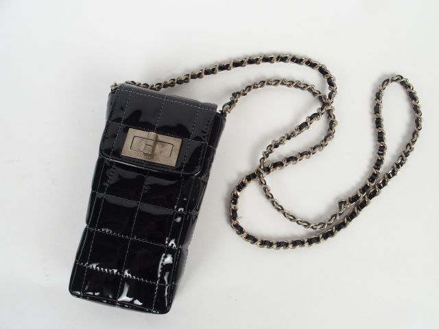 CHANEL. Petit sac en agneau vernis matelassé