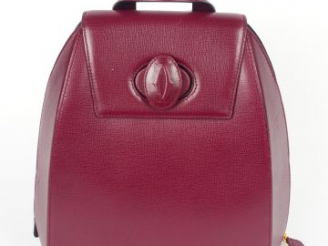 Vente aux enchères CARTIER. Sac à dos en cuir lisse bordeaux. Etat neuf