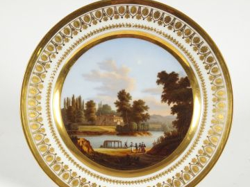Assiette en porcelaine début XIXème à décor en son centre d'un paysage