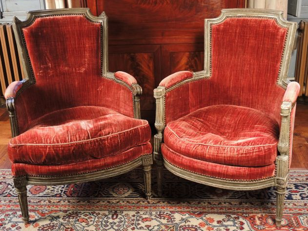 Deux bergères Louis XVI en bois laqué gris mouluré et sculpté, accotoi