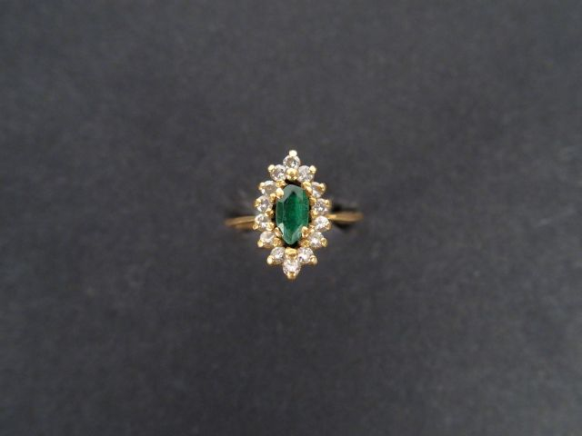 Bague marguerite en or jaune, ornée en son centre d'une émeraude entou