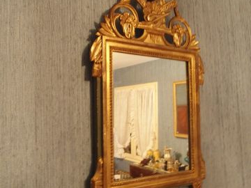 Deux Miroirs de style Louis XVI en bois doré, fronton ajouré à décor d