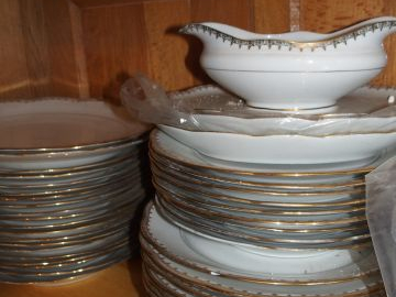 Partie de service de table en porcelaine blanche rehaussée d'or