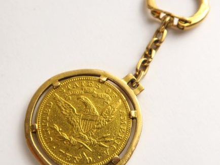 Pièce de 10 Dollars 1894  monté en porte-clé. L'Ensemble en or. Poids 