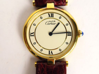 Vente aux enchères CARTIER.  Montre, modèle Must, cadran en vermeil, bracelet en cuir. Ma