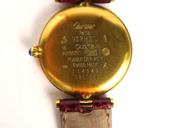 CARTIER.  Montre, modèle Must, cadran en vermeil, bracelet en cuir. Ma