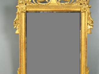 Vente aux enchères 	Miroir Louis XVI en bois sculpté et doré, à décor de rais de coeur, d