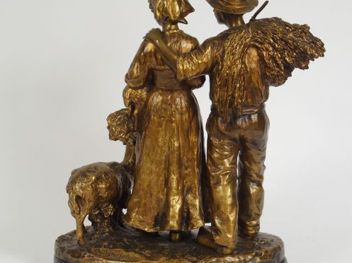 J. d’ASTE. Sculpture en bronze à patine dorée, "Couple de paysans et l