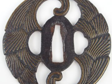 Deux tsuba en fer, l’une dont la surface irrégulière est ornée en taka