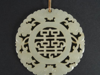 Vente aux enchères Pendentif circulaire en jade céladon, décor de caractères Fu et de cha