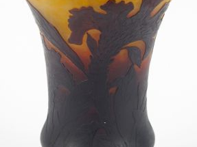 DAUM. Vase cornet en verre, à décor de fleurs mauves sur fond brun et 