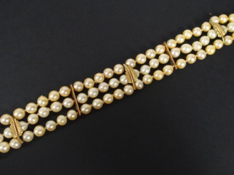 Vente aux enchères Bracelet 3 rangs de perles de culture, agrémenté de 3 motifs de feuill