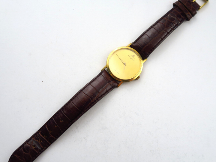 BAUME ET MERCIER. Montre d'homme, boitier en or, bracelet en cuir non 