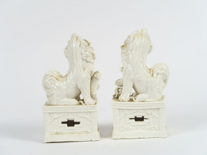 Paire de chien de Fô en porcelaine blanche formant porte baguettes à e
