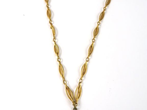 Pièce de 20 francs or montée en pendentif, avec sa giletière. Poids : 