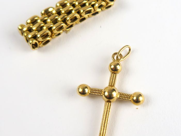 14/ Bague articulée et croix en or. Poids : 4,9 g