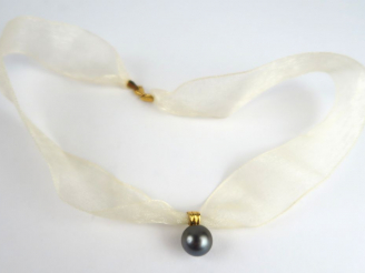Vente aux enchères Perle grise montée en pendentif, monture en or, avec son lien.