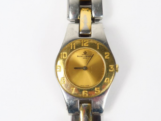 Vente aux enchères BEAUME ET MERCIER. Montre de dame en acier (usures d'usage)