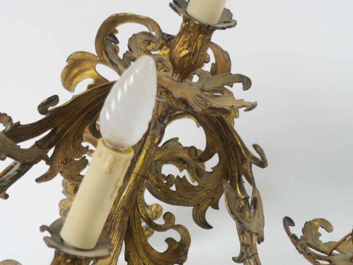 Paire d'appliques de style rocaille en métal doré. Eclairant à quatre 