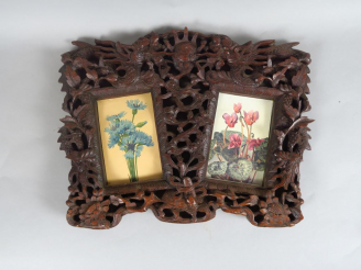 Vente aux enchères Cadre en bois naturel finement sculpté et ciselé de deux dragons affro