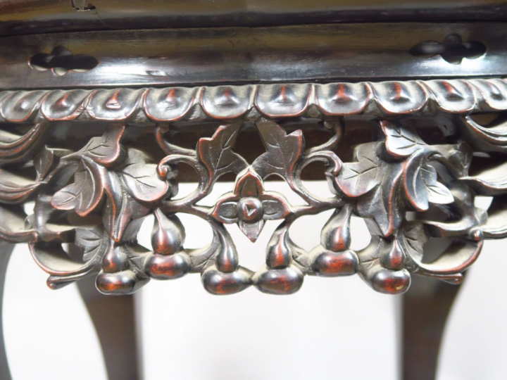 Guéridon en bois de rose à bord polylobé, reposant sur des pieds griff